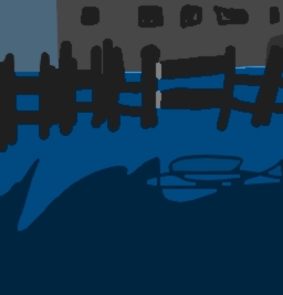 iron fence closed, blue ground. metal building beyond.